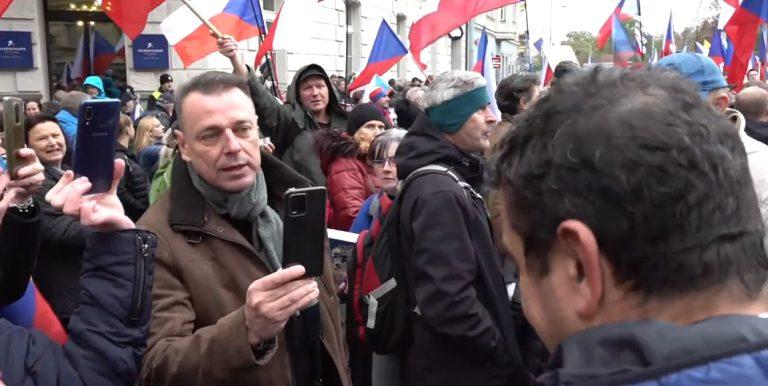 Czech Television reporter Richard Samko (right, back to camera) facing racist insults at the anti-Government demonstration on 17 November 2022.